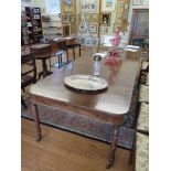 A Regency mahogany extending dining table, the rectangular top with beaded frieze on ring turned