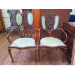 A late 19th century mahogany open armchair, the pierced shell form back with two pads over a