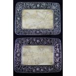 Two Japanese Meiji period dishes having an ivory plaque encased in white metal frames with pierced