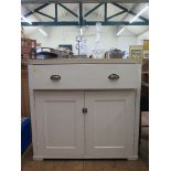 A painted pine side cabinet, the later formica top over a long drawer and twin cupboard doors, 100cm