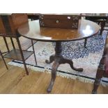 A George III style mahogany tripod table, the circular top on a birdcage hinge and baluster