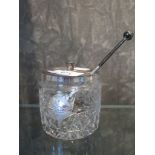 A glass preserve pot with silver lid