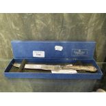 A silver handled bread knife, boxed