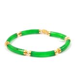 A jade bracelet set in 14 carat gold