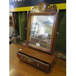 A George III style mahogany toilet mirror, the fret carved top over a rectangular plate on a chevron