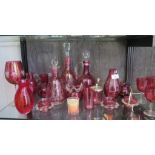 Three cranberry glass decanters, various cranberry glasses, vases and pots