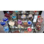 Sixteen various paperweights, including a Caithmess Moon Crystal weight