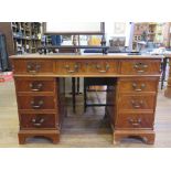 A reproduction mahogany pedestal desk, with leather inset top, filing drawer and seven other