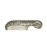 An Oriental white metal comb in the form of a dragon, with two character mark 16.5cm wide