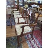 A set of six George III style dining chairs, with two carvers, the foliate scroll top rails over