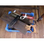 Various woodworking tools, including leather covered tape measure, hand drills, squares and saws
