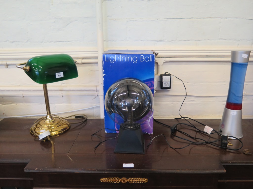 A brass and green glass club table lamp, 38cm high, a lava lamp and a lightening ball (3)