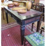 An ebonised side table with rush inset top over three drawers on square tapering legs 140.5cm wide