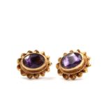 A pair of amethyst earrings set in 9 carat gold