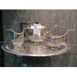 A Victorian three piece silver tea set of half ribbed design, Birmingham 1897 on an E.P. tray