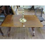 A mahogany low occasional table, the rectangular top on outsplayed legs joined by a pole