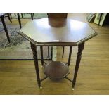 An Edwardian mahogany octagonal window table, with turned legs, undershelf and pot castors 73cm