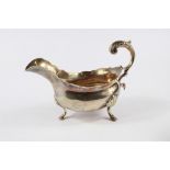 A George III silver gravy boat, on three shell and hoof feet, London 1765