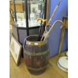 A brass bound oak barrel with various walking sticks and hunting stick