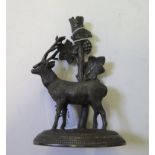 A late Victorian cast metal figure of a stag before a grape vine, 13cm high