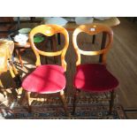 A pair of Victorian balloon back bedroom chairs, with upholstered seats, turned legs and stretchers