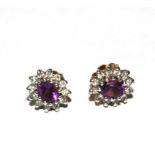 A pair of diamond and amethyst earrings