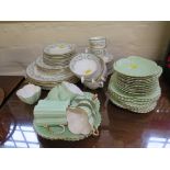 A Paragon china part breakfast service with blue floral scroll border, 35 pieces, and a green