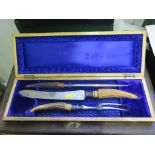 A cased carving set with antler handles