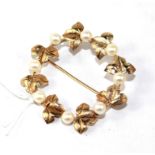 A gold and pearl set brooch