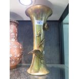 A brass Secessionist style waisted vase with applied flower motif, 31cm high