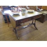 A Regency style mahogany sofa table, the leather inset top and leaves over two frieze drawers on