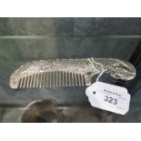 An Oriental white metal comb in the form of a dragon, with two character mark 16.5cm wide