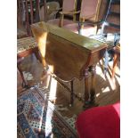A mid Victorian walnut Sutherland table, the shaped top on baluster turned supports joined by