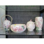 A Maling lustreware teapot with pink floral decoration, 17cm high, a matching biscuit caddy, fruit