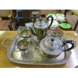 A four piece silver plated tea set on trays and a pair of plated coasters