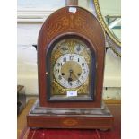An Edwardian inlaid mahogany bracket clock, the arched cased enclosing a brass dial with silvered