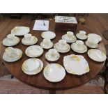 A Foley china part tea service with hand painted crocus design in yellow, 37 pieces