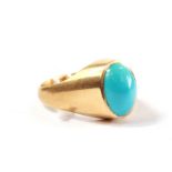 A gold colour metal ring set with fine colour turquoise