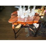 An Edwardian stained beech window table with patera inlay, the shaped square top on cabriole legs