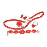 A ring, earrings, necklace set with red stones