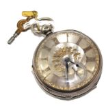 A silver pocket watch with silver dial and gold numerals