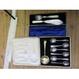 A boxed set of fish servers and a boxed set of soup spoons