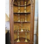 Seven pairs of turned brass candlesticks and a single candlestick, largest 27cm high