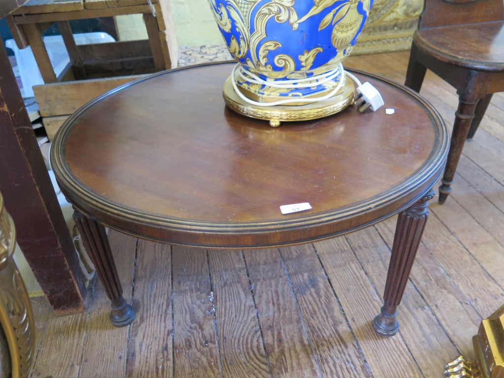 A Regency style mahogany coffee table, the circular top on reeded legs, 71cm diameter