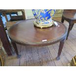 A Regency style mahogany coffee table, the circular top on reeded legs, 71cm diameter