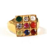 A gem set diamond ruby sapphire emerald ring in square form