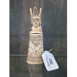 An ethnic tribal carved bone bottle depicting rutting animals, with figural stopper 13.5cm high