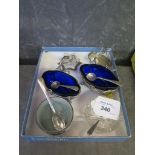 A pair of silver plated basket salts with blue liners together with four others, all with spoons