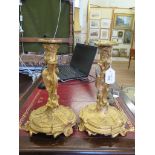 A pair of Rococo revival ormolu candlesticks, late 19th century, of scroll and cartouche form with