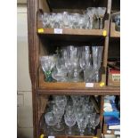 A large collection of drinking glasses, including some cut glass (three trays)